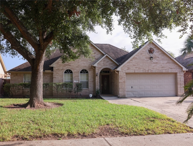 view of front facade with a garage and a front lawn