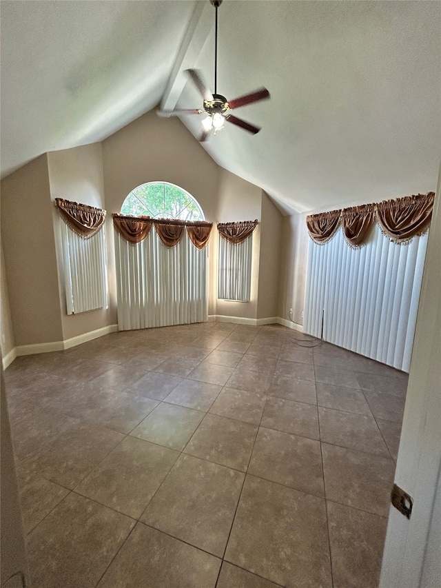 tiled spare room with vaulted ceiling and ceiling fan