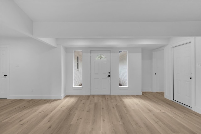 foyer entrance with light hardwood / wood-style floors