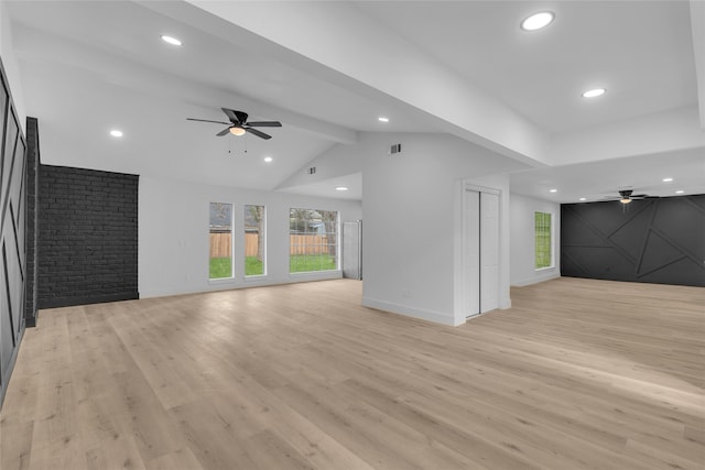 unfurnished living room featuring vaulted ceiling with beams, ceiling fan, and light hardwood / wood-style floors