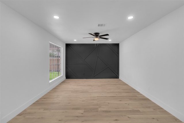 spare room featuring light wood-type flooring and ceiling fan