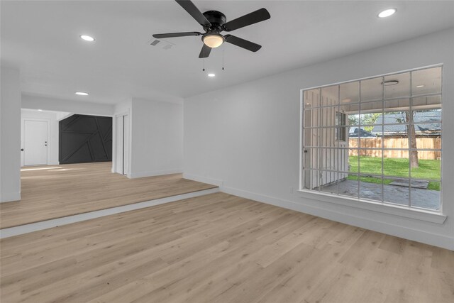 unfurnished living room featuring ceiling fan and light hardwood / wood-style flooring