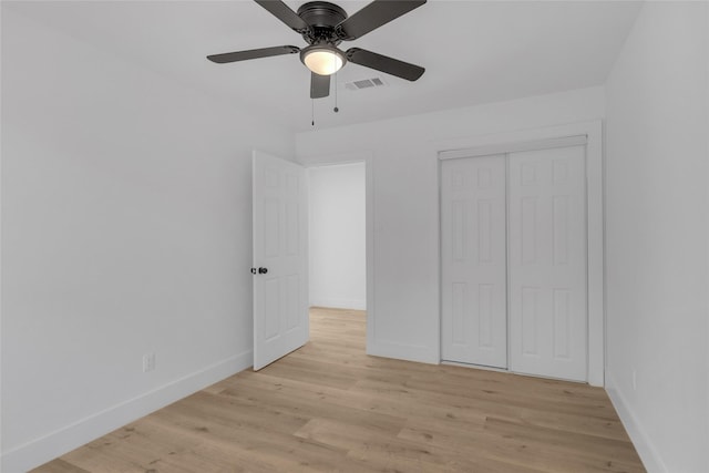 unfurnished bedroom with light wood-type flooring, a closet, and ceiling fan