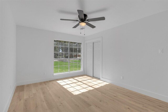 empty room featuring ceiling fan and light hardwood / wood-style floors