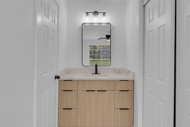 bathroom with ceiling fan and vanity