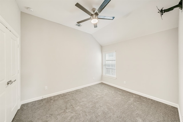 unfurnished room featuring ceiling fan, vaulted ceiling, and carpet floors