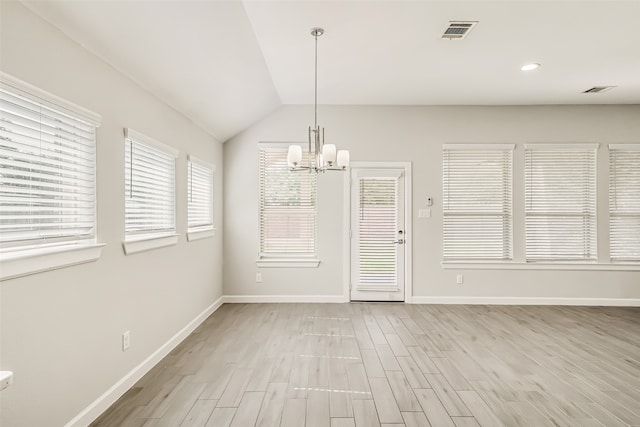 unfurnished dining area featuring light hardwood / wood-style flooring, vaulted ceiling, and a notable chandelier