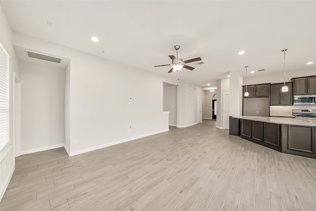 unfurnished living room with ceiling fan and light hardwood / wood-style flooring