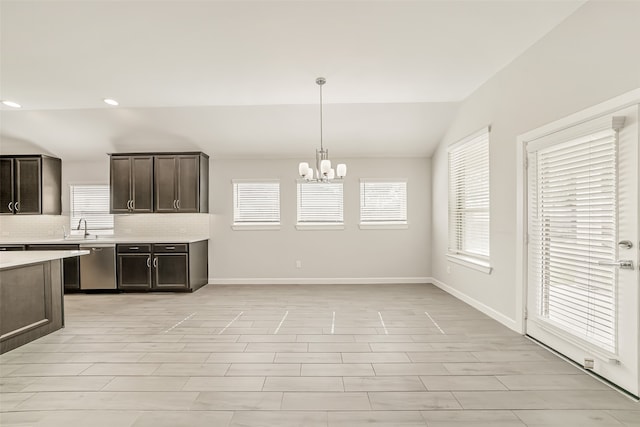 kitchen featuring dark brown cabinetry, a notable chandelier, dishwasher, pendant lighting, and vaulted ceiling