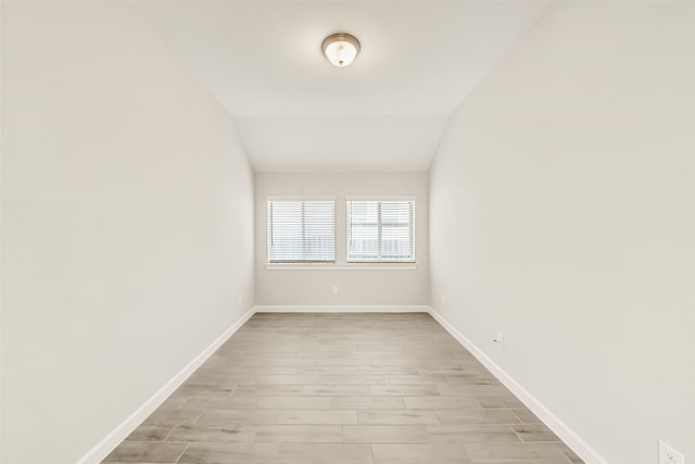 empty room featuring light hardwood / wood-style floors and lofted ceiling