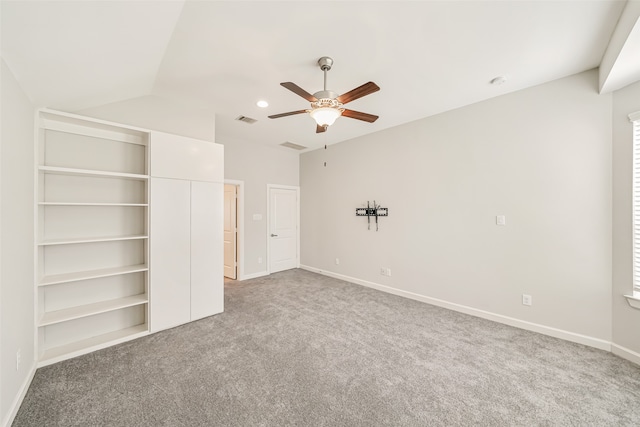 unfurnished bedroom with ceiling fan, lofted ceiling, and carpet