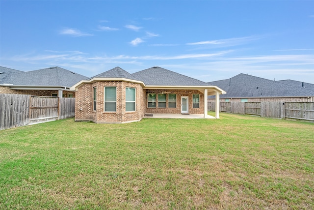 back of property featuring a patio area and a yard