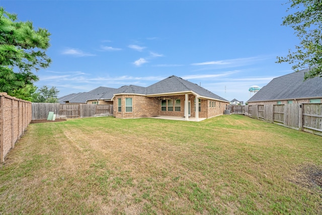 rear view of property with a patio and a yard