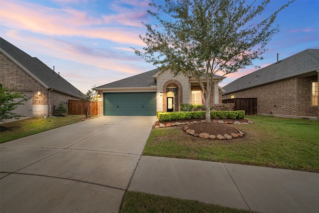 view of front facade featuring a garage and a lawn