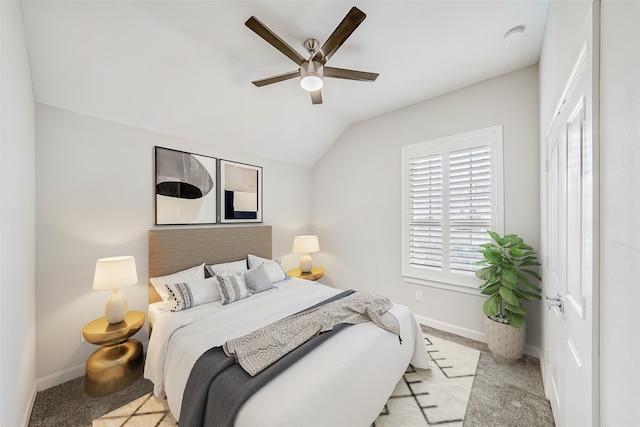 carpeted bedroom featuring vaulted ceiling and ceiling fan