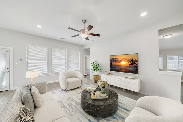 living room featuring hardwood / wood-style floors, plenty of natural light, and ceiling fan