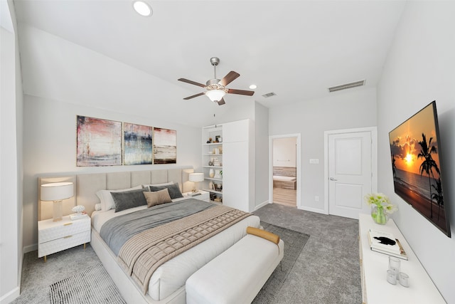 carpeted bedroom with ensuite bathroom and ceiling fan