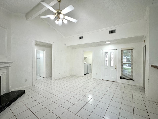 unfurnished living room featuring light tile patterned flooring, ceiling fan, a textured ceiling, washer and clothes dryer, and lofted ceiling with beams