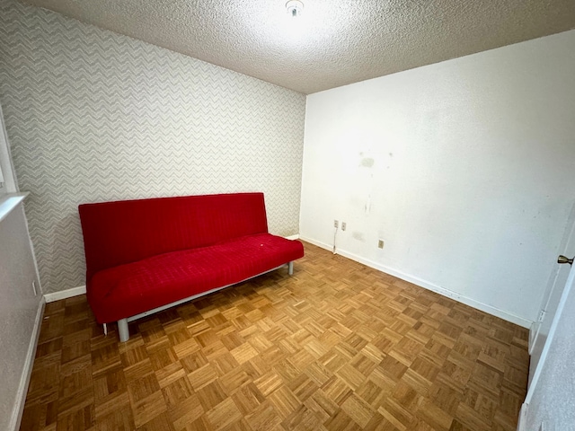 living area with parquet flooring and a textured ceiling