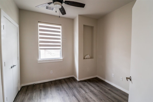 empty room featuring wood-type flooring and ceiling fan