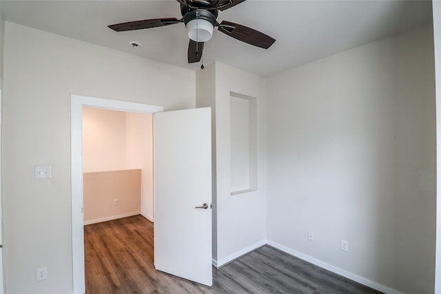 spare room featuring dark hardwood / wood-style floors and ceiling fan