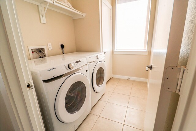 4508 Clover St, Houston, TX 77051 - laundry area featuring washer and dryer, light tile patterned floors, and baseboards