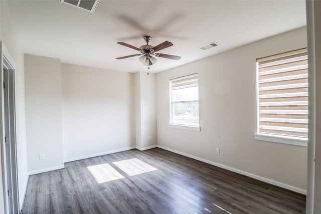 spare room featuring ceiling fan and dark hardwood / wood-style flooring