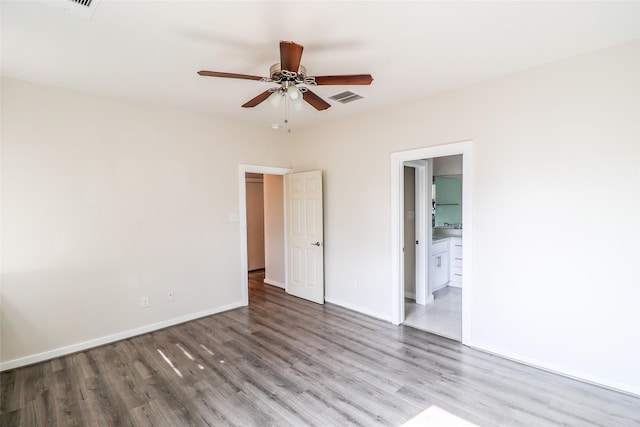 4508 Clover St, Houston, TX 77051 - unfurnished bedroom featuring wood finished floors, baseboards, ensuite bathroom, and ceiling fan