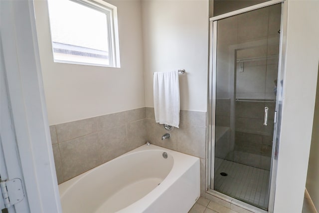 bathroom featuring tile patterned floors and shower with separate bathtub