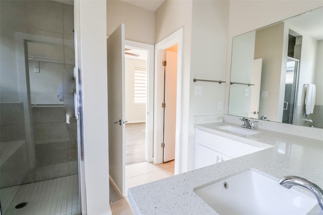 bathroom with tile patterned flooring, vanity, and a shower with shower door