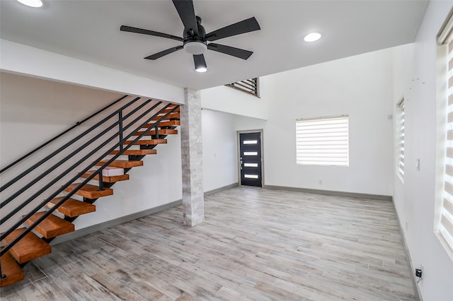 unfurnished living room with ceiling fan and light hardwood / wood-style floors