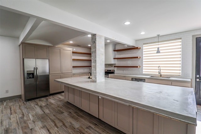 4508 Clover St, Houston, TX 77051 - kitchen with appliances with stainless steel finishes, open shelves, a sink, ornate columns, and dark wood finished floors