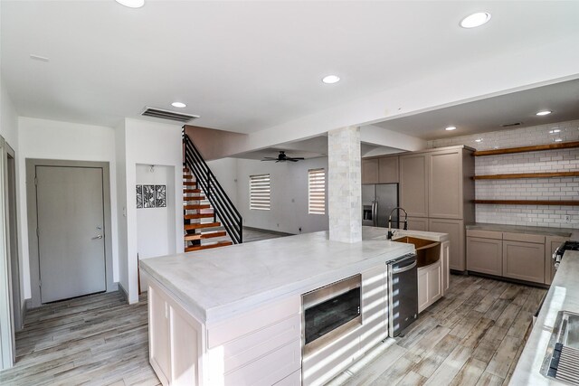 4508 Clover St, Houston, TX 77051 - kitchen featuring a sink, appliances with stainless steel finishes, light wood-style floors, ornate columns, and recessed lighting