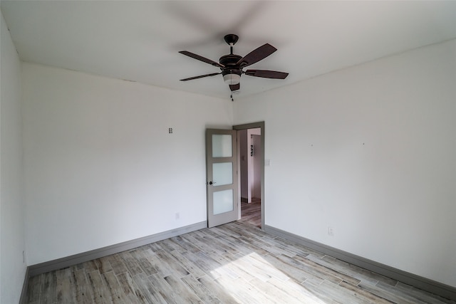 spare room with ceiling fan and light hardwood / wood-style floors