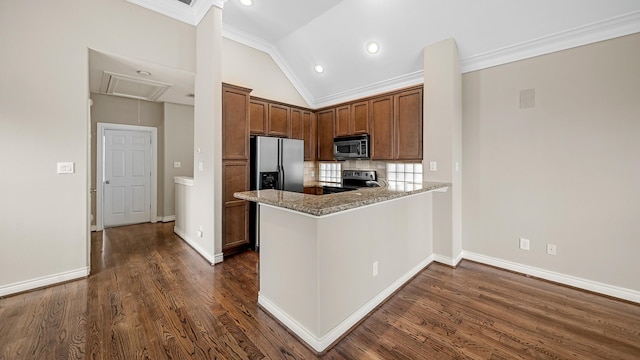 kitchen featuring light stone countertops, dark wood-type flooring, lofted ceiling, and appliances with stainless steel finishes