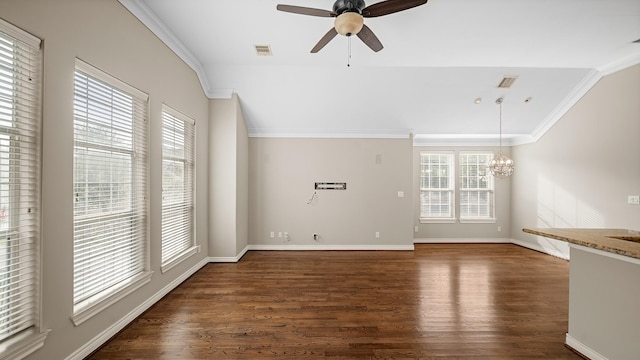 unfurnished living room featuring dark wood-type flooring, ceiling fan with notable chandelier, and ornamental molding