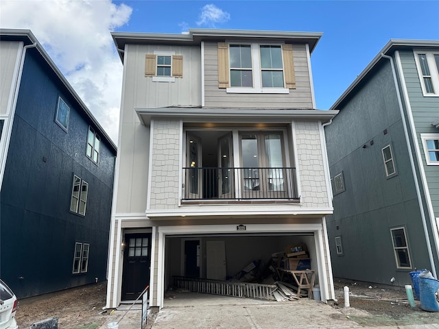 view of property with a garage and a balcony