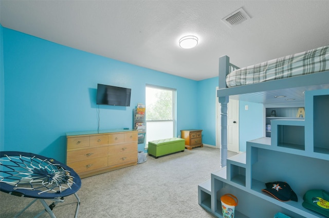 bedroom with carpet and a textured ceiling