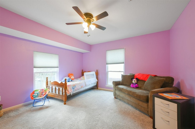 bedroom with ceiling fan and light carpet