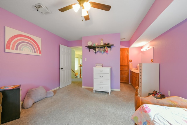 carpeted bedroom with ceiling fan and ensuite bathroom