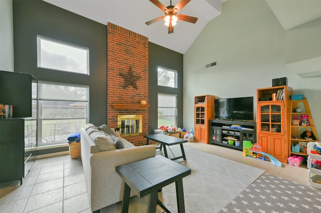 living room featuring light tile patterned floors, high vaulted ceiling, ceiling fan, and a brick fireplace