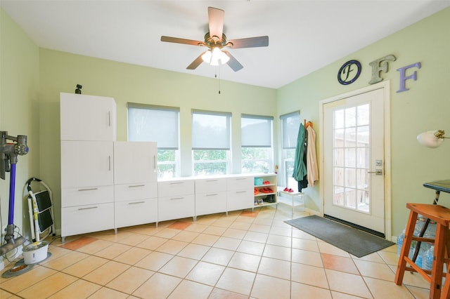 entryway featuring ceiling fan, light tile patterned floors, and a healthy amount of sunlight