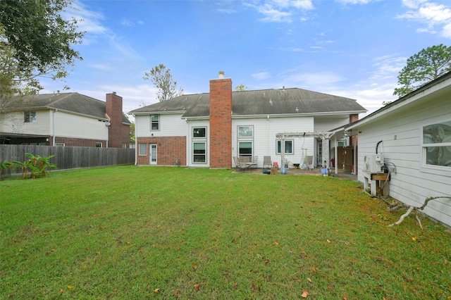 rear view of house with a lawn