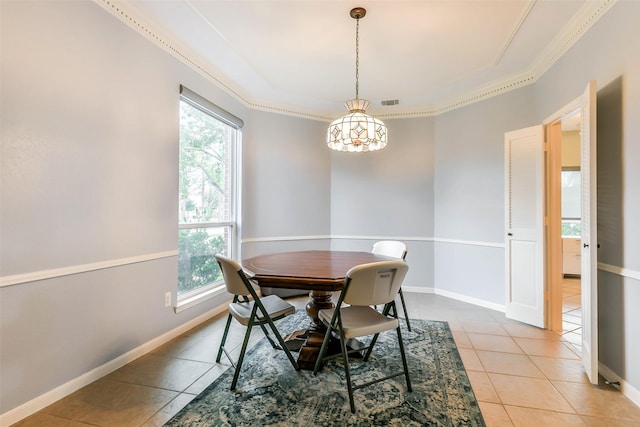 dining area featuring light tile patterned flooring, a healthy amount of sunlight, and ornamental molding