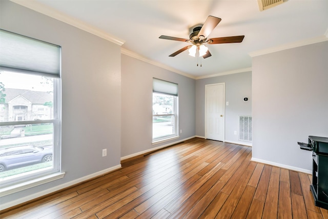 spare room with light hardwood / wood-style flooring, ceiling fan, and crown molding