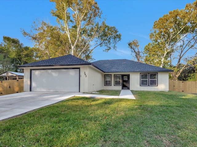 ranch-style home featuring a garage and a front yard