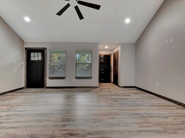 interior space featuring ceiling fan, light hardwood / wood-style flooring, and lofted ceiling