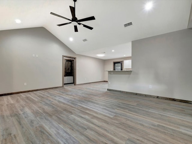 unfurnished living room featuring light hardwood / wood-style floors, ceiling fan, and vaulted ceiling