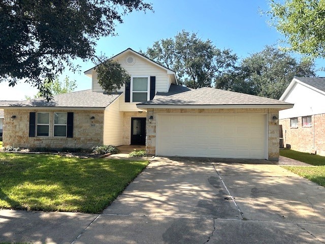 view of front of home featuring a garage and a front lawn