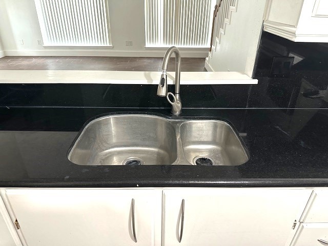 room details with white cabinetry and sink